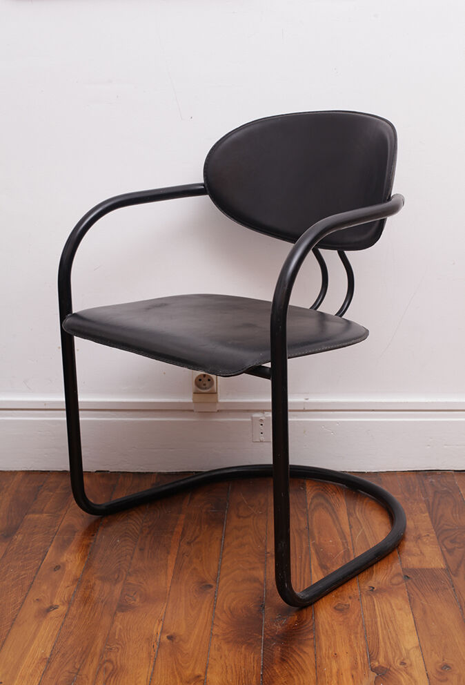 Black armchair with arched legs