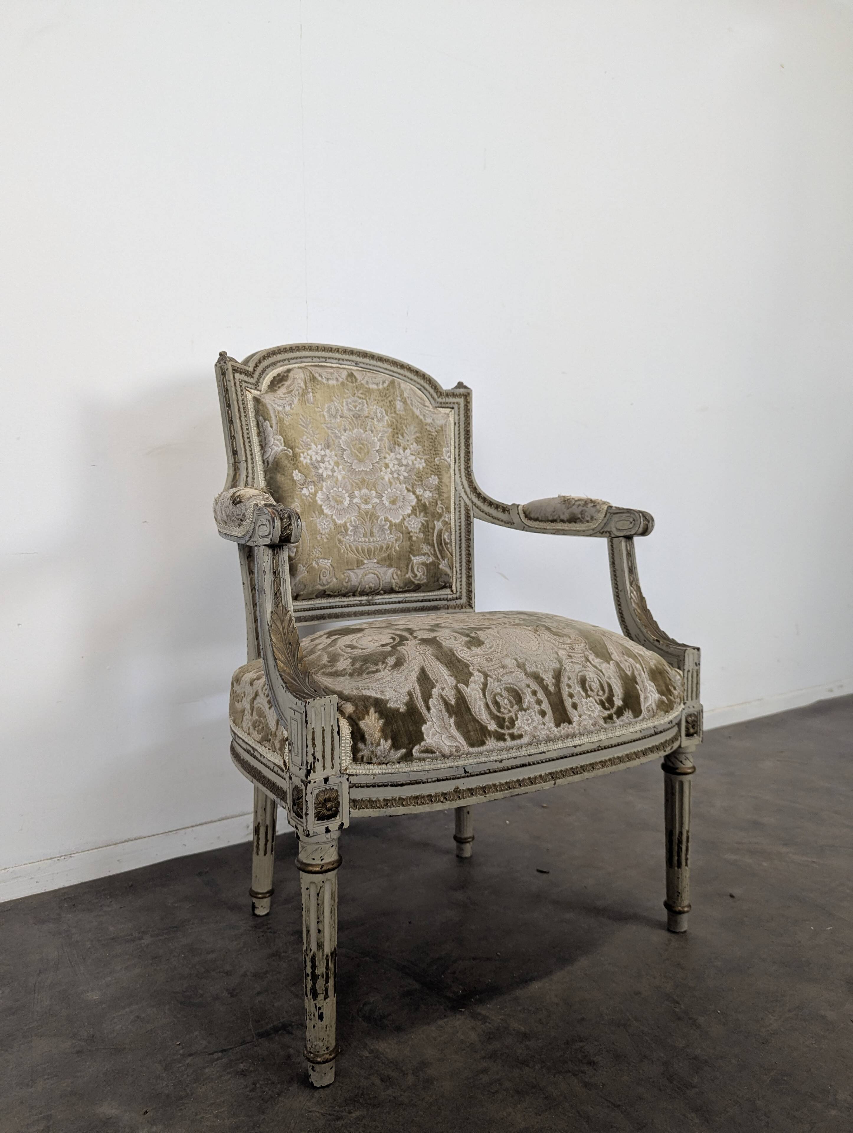 Cream lacquered Louis XVI style cabriolet salon with gold highlights.