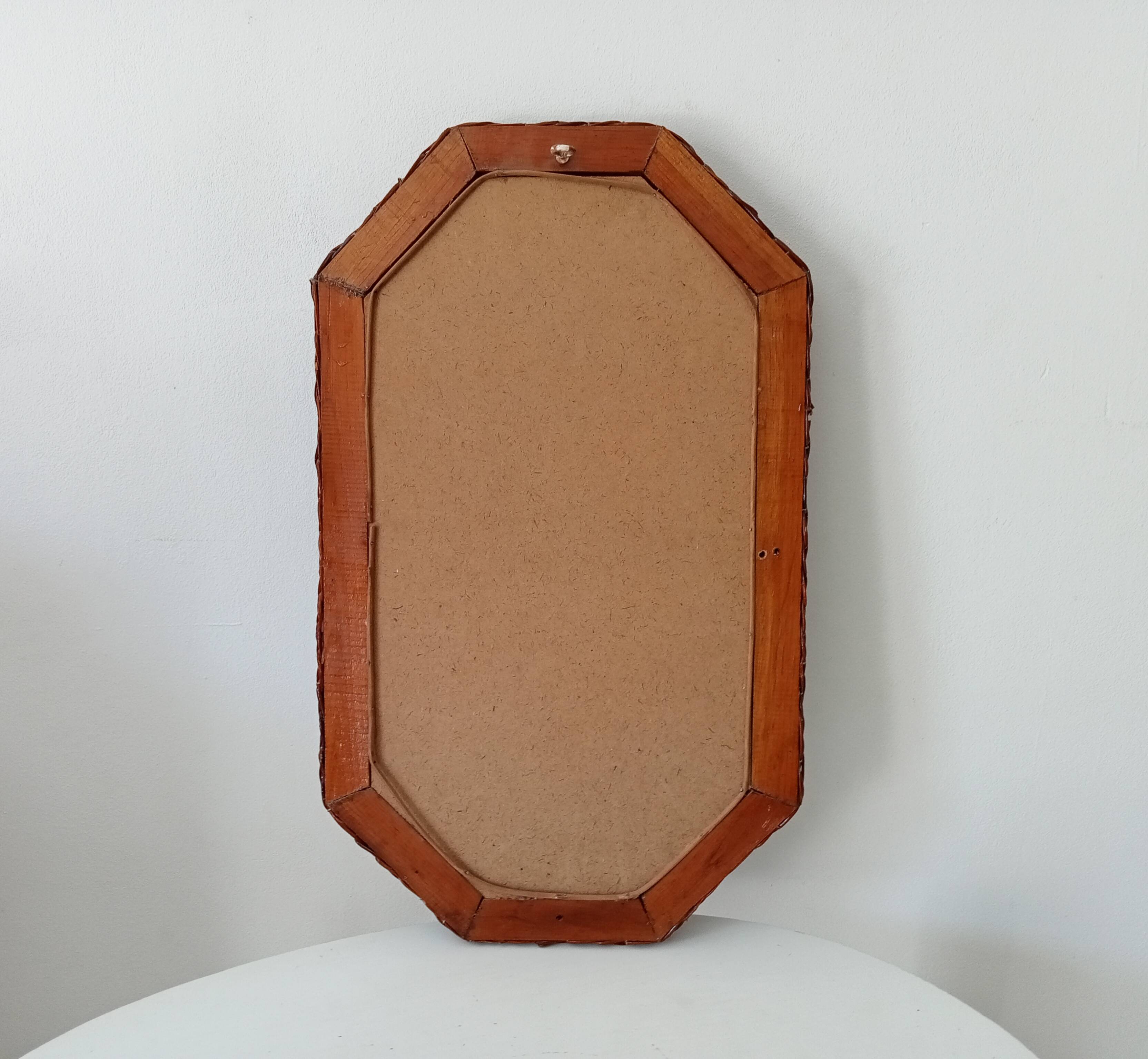 Vintage octagonal mirror in woven rattan.