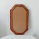 Vintage octagonal mirror in woven rattan.