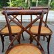 4 bistro chairs with curved wooden backs and cross braces / Crossback