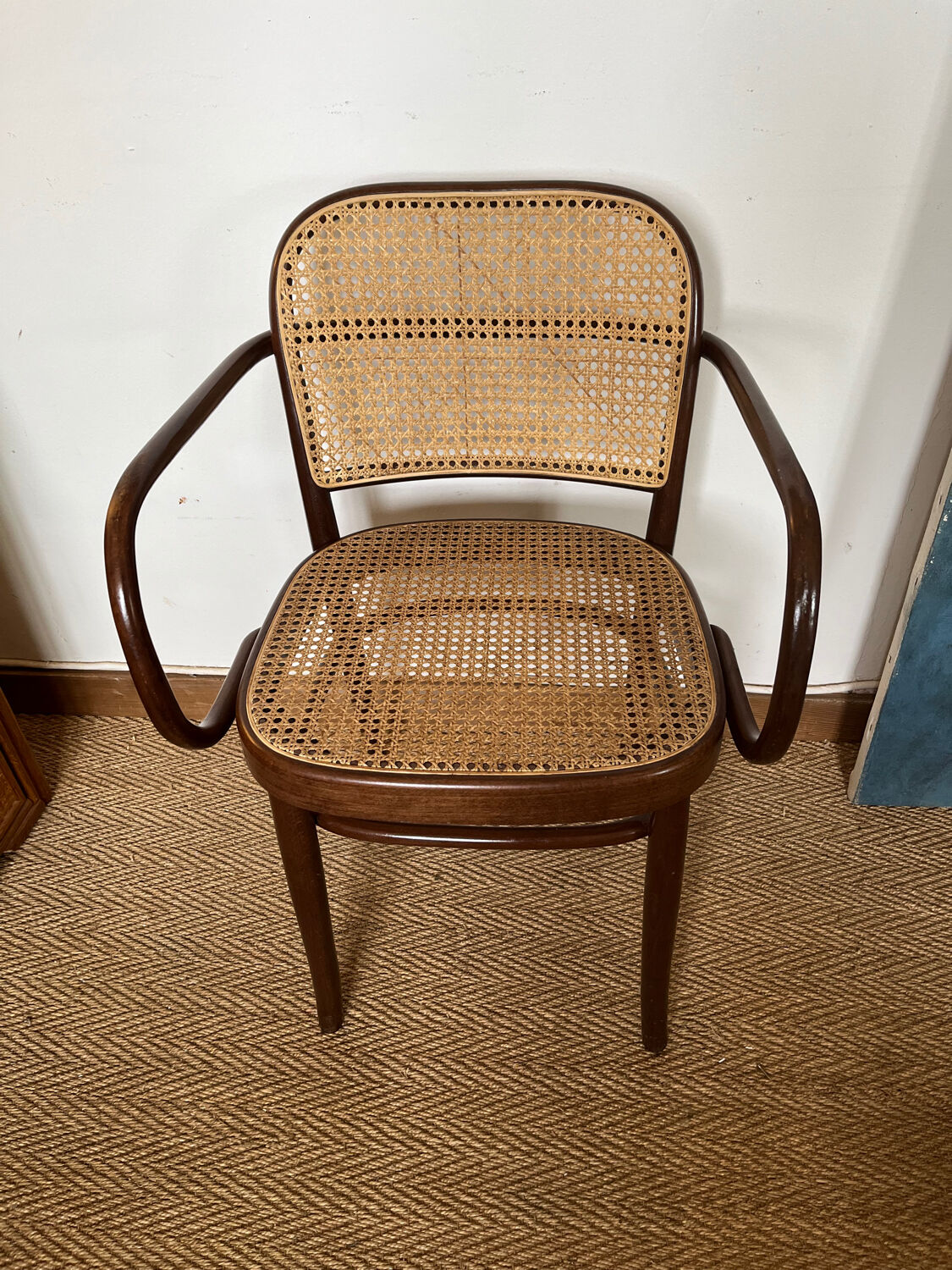Curved wood and cane armchair