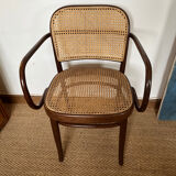 Curved wood and cane armchair
