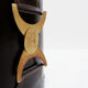 Brown leather wastepaper basket with decorative gold metal buckle.