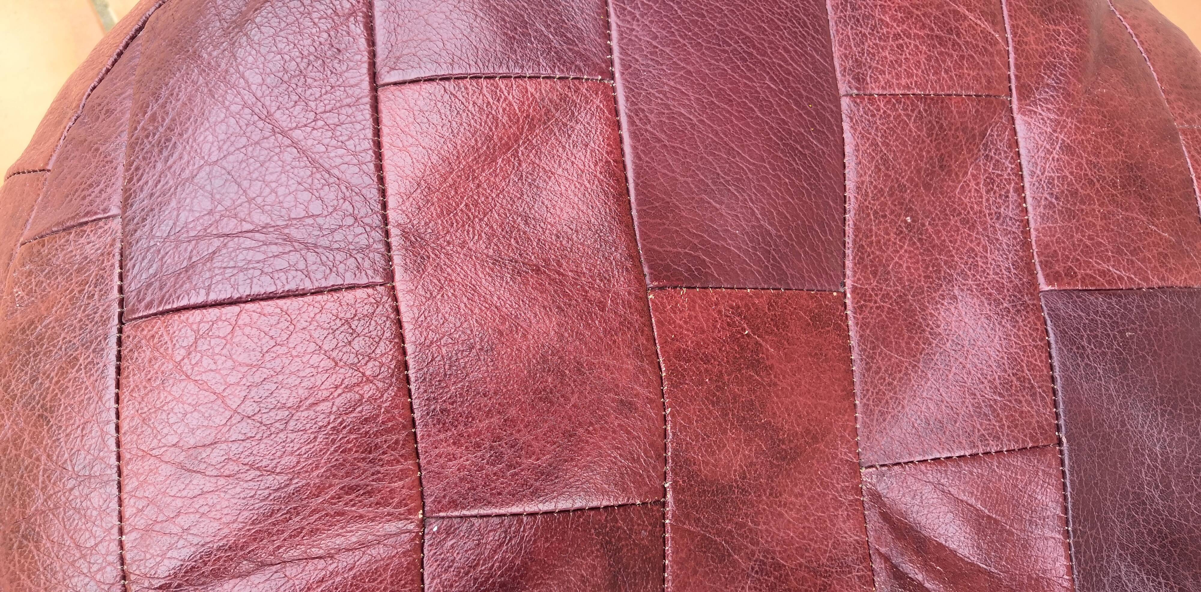Pair of vintage poufs in burgundy leather patchwork, 1970