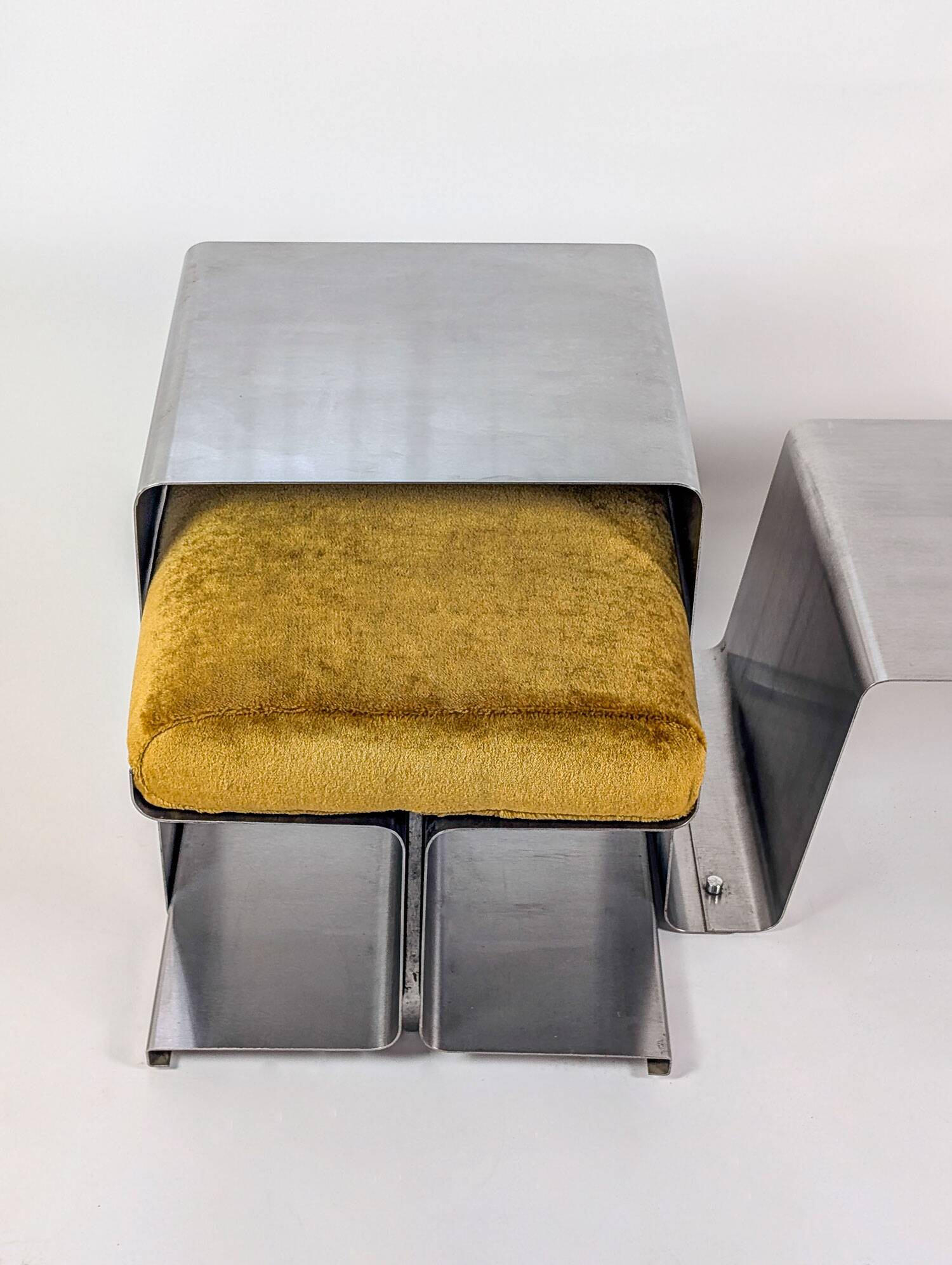 Stainless steel coffee table and stool, by the Roche Bobois design office, 1970