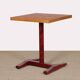 Square wooden dining table with a pedestal from the 1980s.