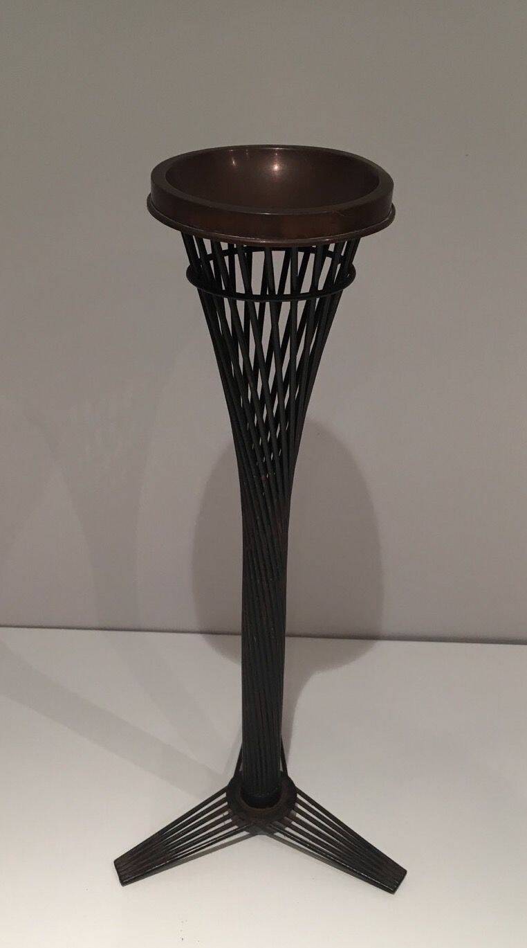 Brass ashtray on a stand made of black lacquered metal wire.