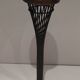 Brass ashtray on a stand made of black lacquered metal wire.