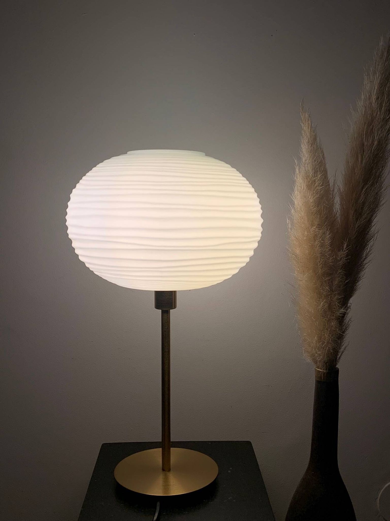 Table lamp made with an old globe in streaked white glass and a golden foot