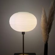 Table lamp made with an old globe in streaked white glass and a golden foot