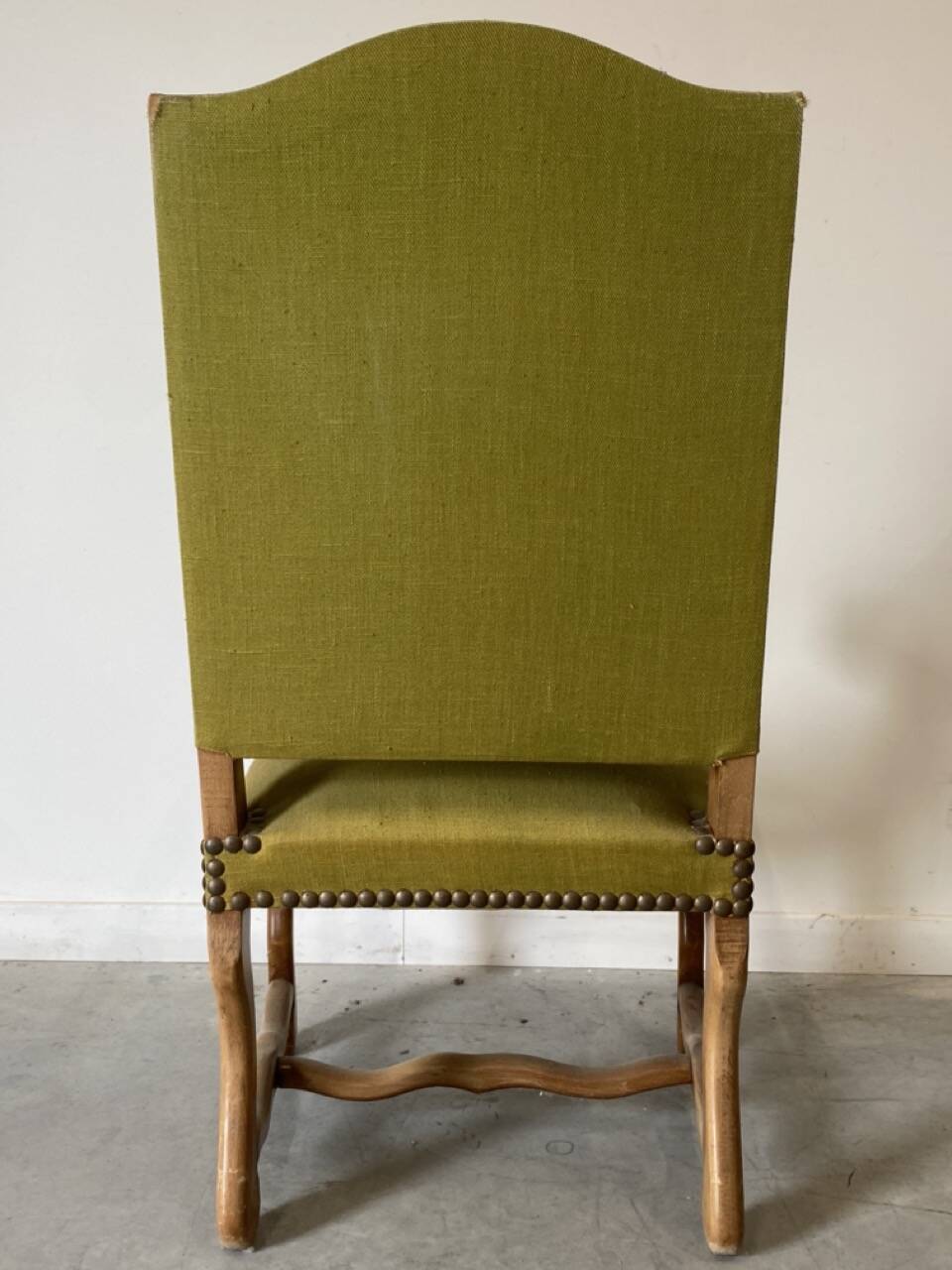 Olive green upholstered armchairs with studs