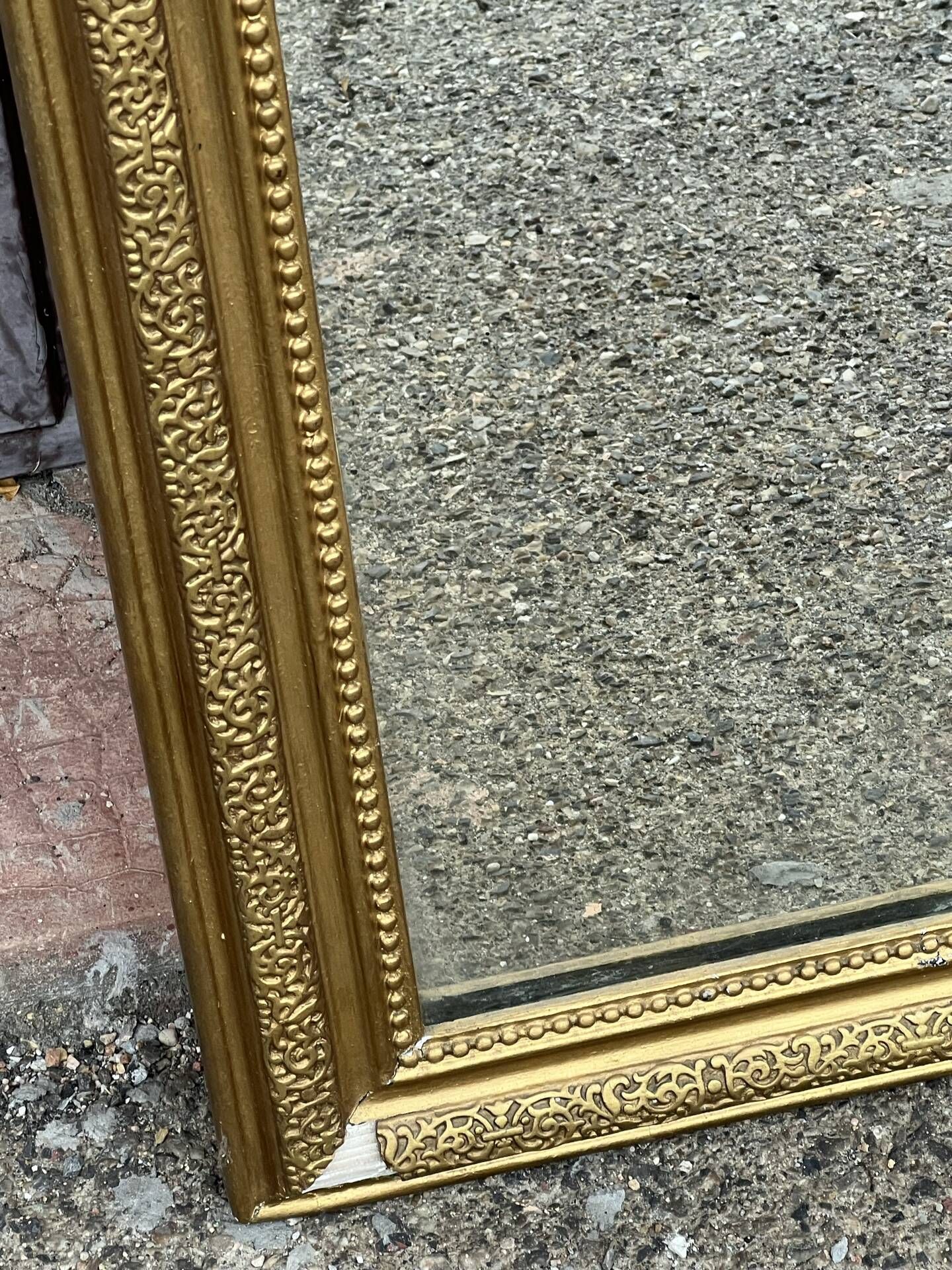 Louis Philippe mirror in gilded wood with an openwork frieze and mercury glass.