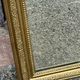 Louis Philippe mirror in gilded wood with an openwork frieze and mercury glass.