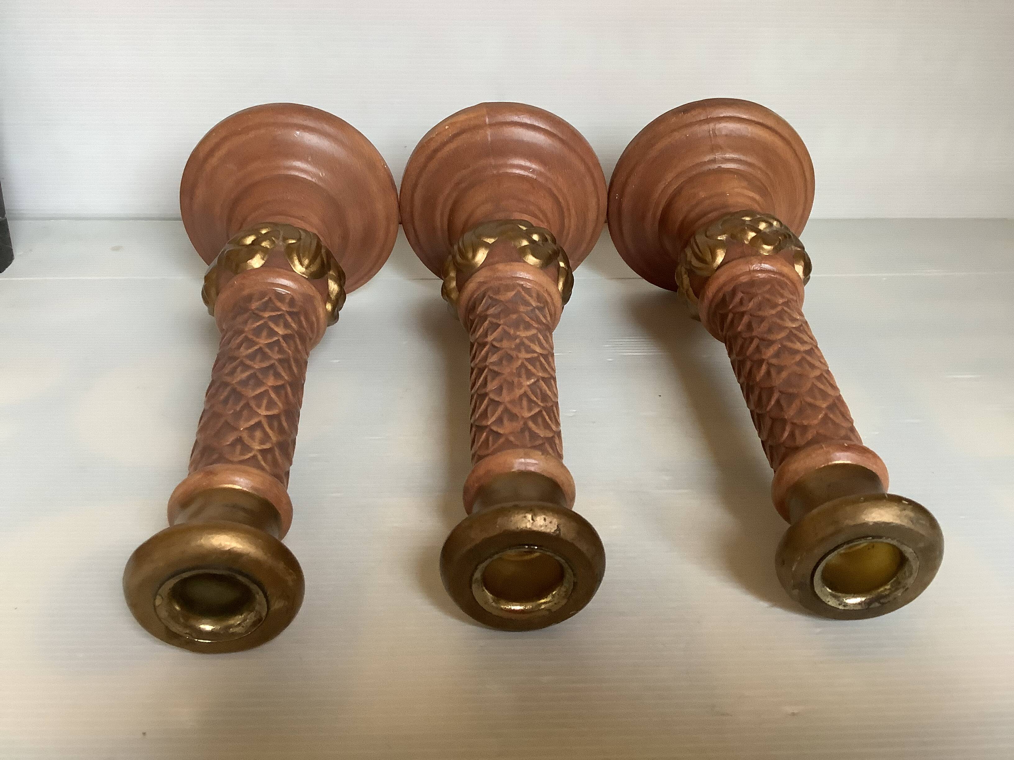 Trio of large brown and gold candlesticks