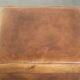 Cowhide ottoman with a beautiful patina finished with decorative nails