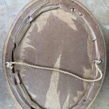 Old oval frame in wood and gilded stucco