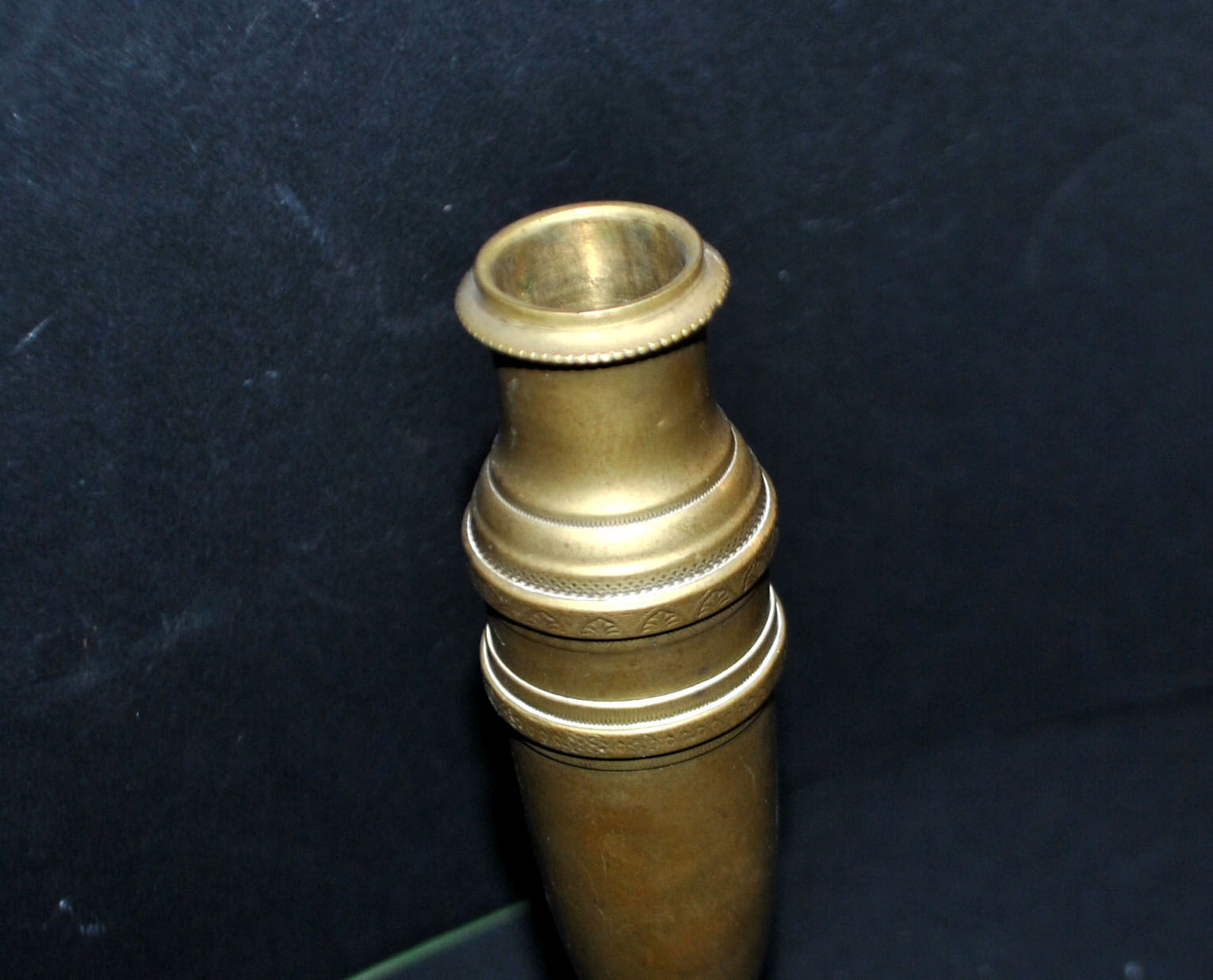 Antique baluster candlestick in bronze with hand-chiseled design.