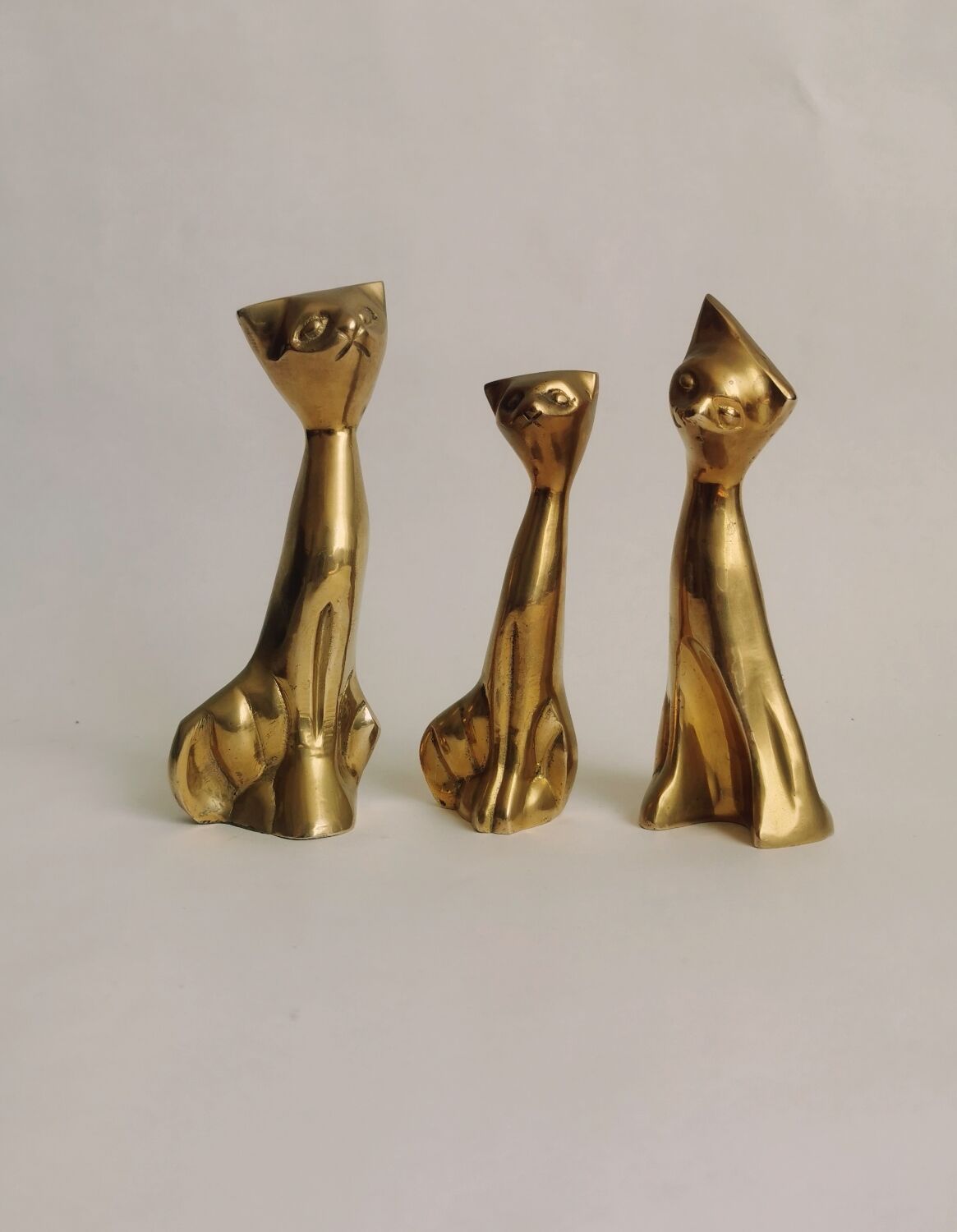 Trio of cats in gilded brass