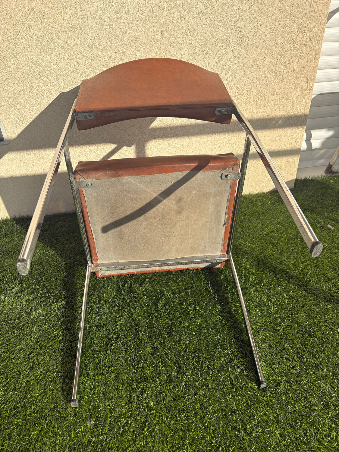 A pair of vintage brown Skaï chairs.
