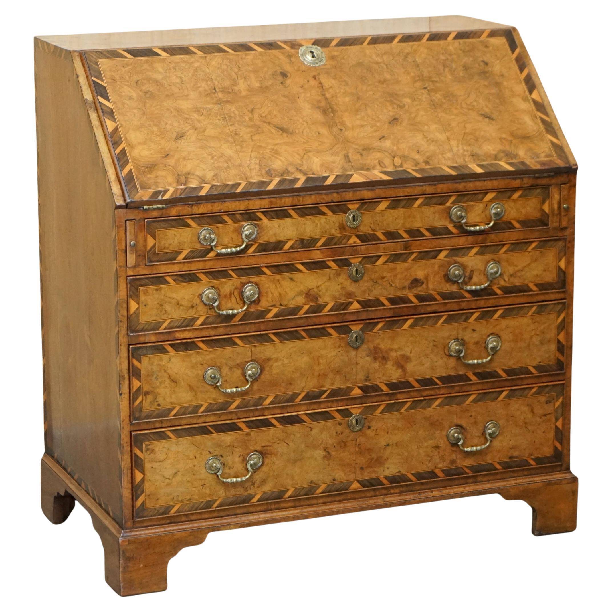 Antique George II bureau from 1740 in walnut, rosewood, and leather.