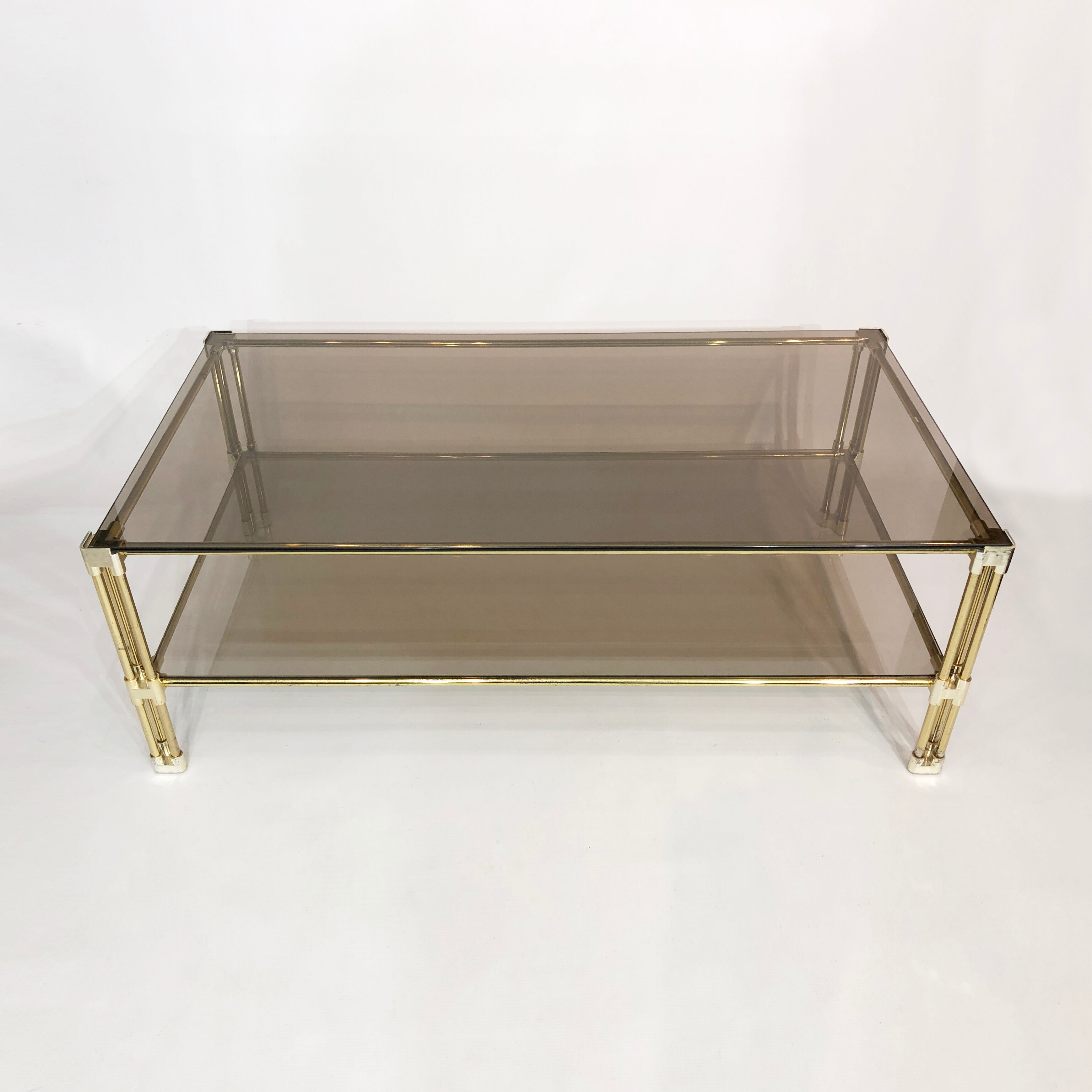 Brass two-tiered coffee table hollywood regency gold smoked glass 1970s