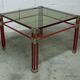 Postmodern Italian design coffee table in smoked glass with red steel structure