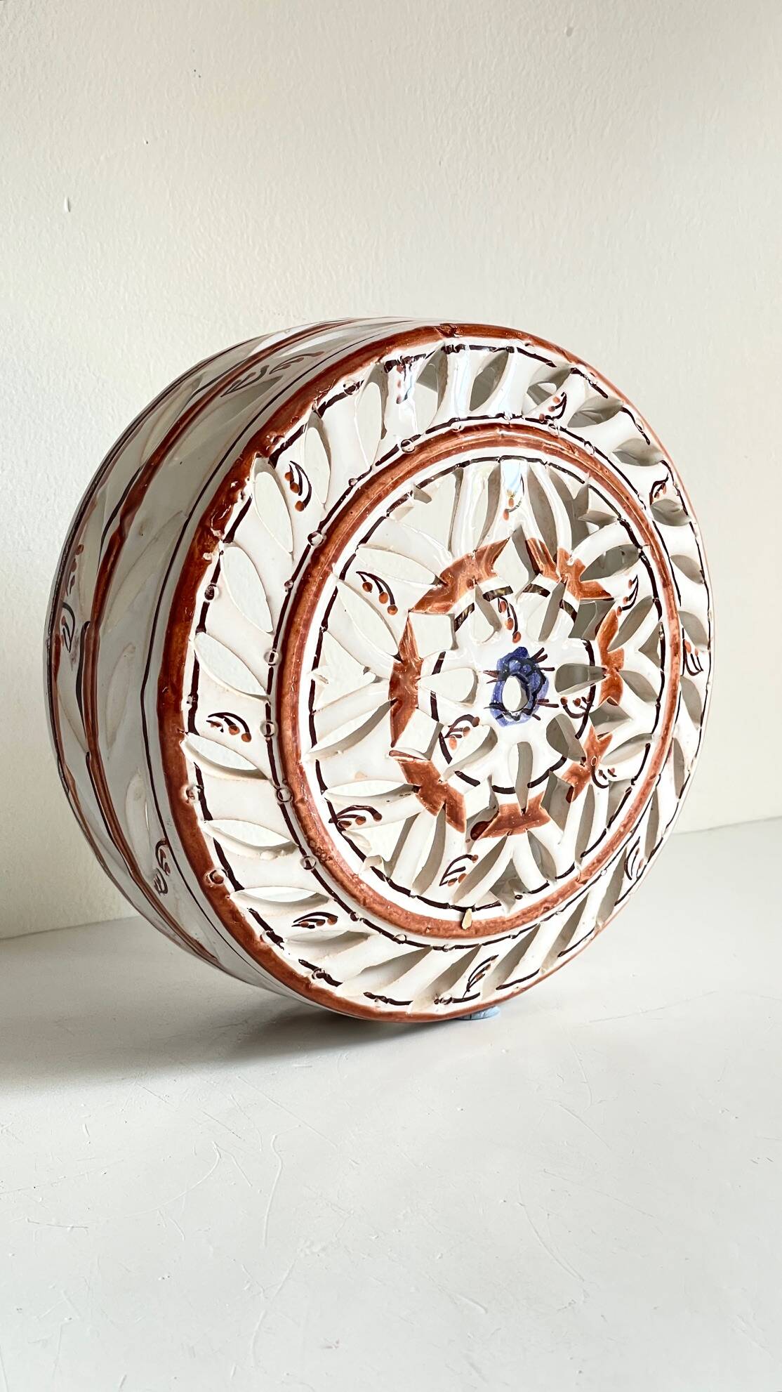 Handmade terracotta wall lamp with blue enamelled center