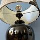 Small Space Age table lamp with a porcelain base and black and white flower shade.