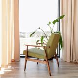 Mid-century modern armchair in olive green bouclé design by H. Lis.