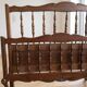Double bed frame in antique Louis XV style made of solid wood.