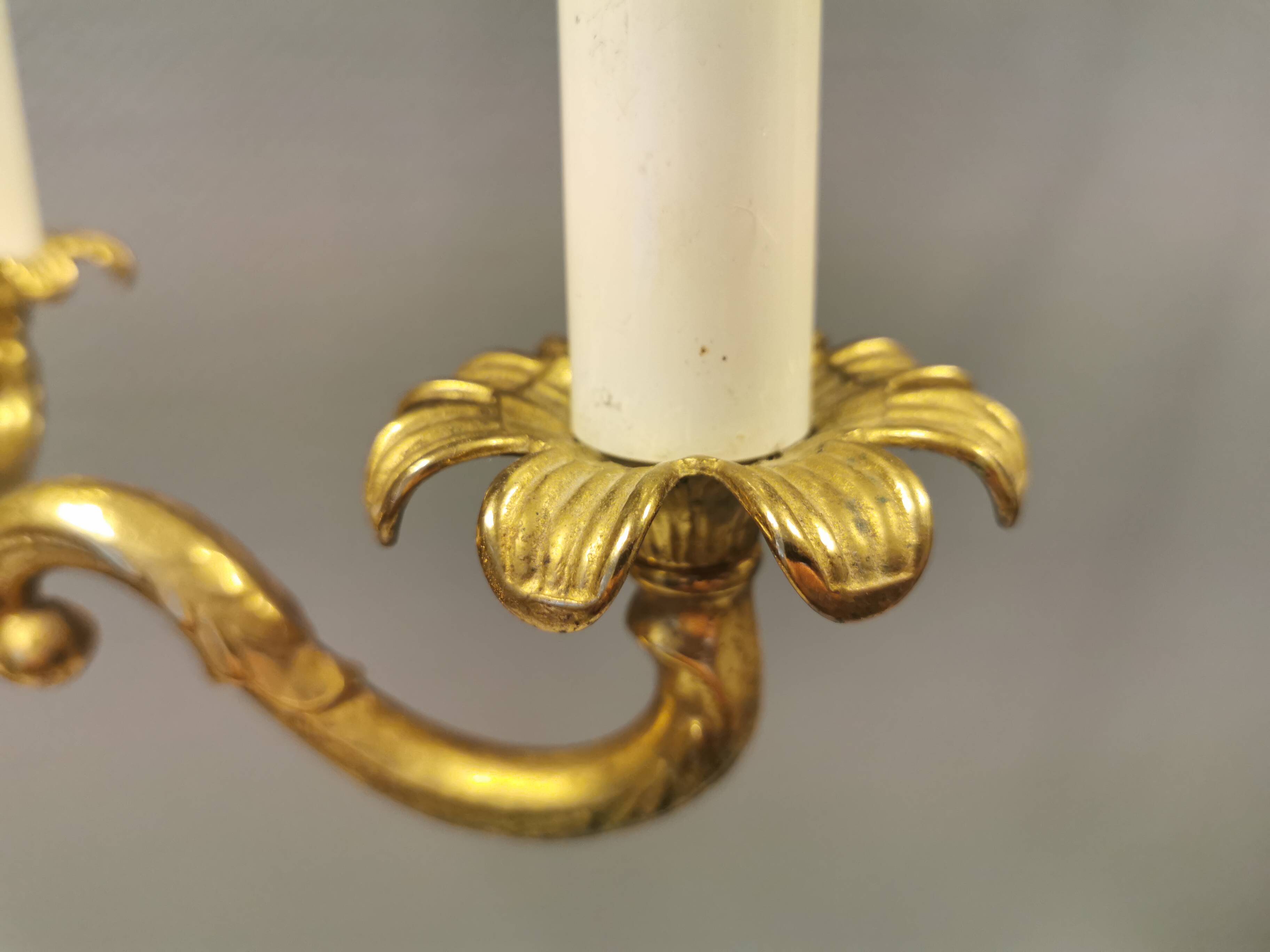 Older brass alloy chandelier with three light sources.