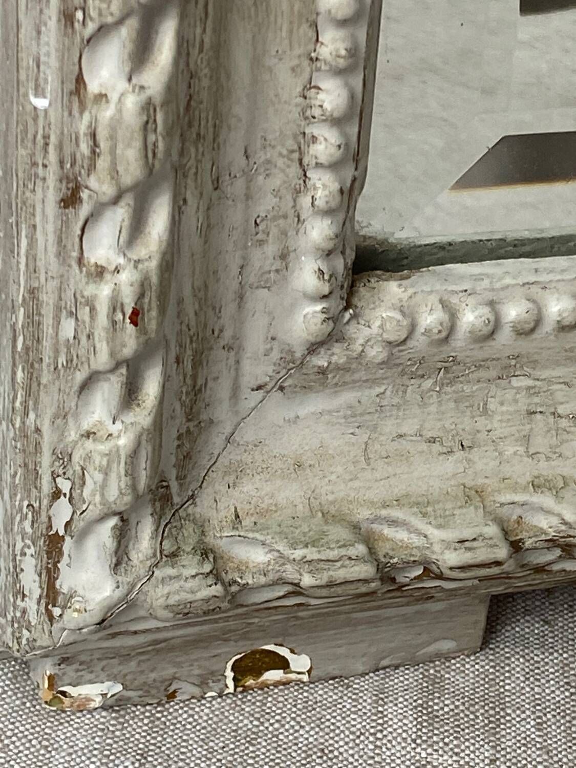 Large antique beveled mirror in carved wood painted with floral decoration and