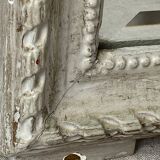 Large antique beveled mirror in carved wood painted with floral decoration and