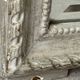 Large antique beveled mirror in carved wood painted with floral decoration and