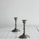 Pair of small metal candle holders, classic design.