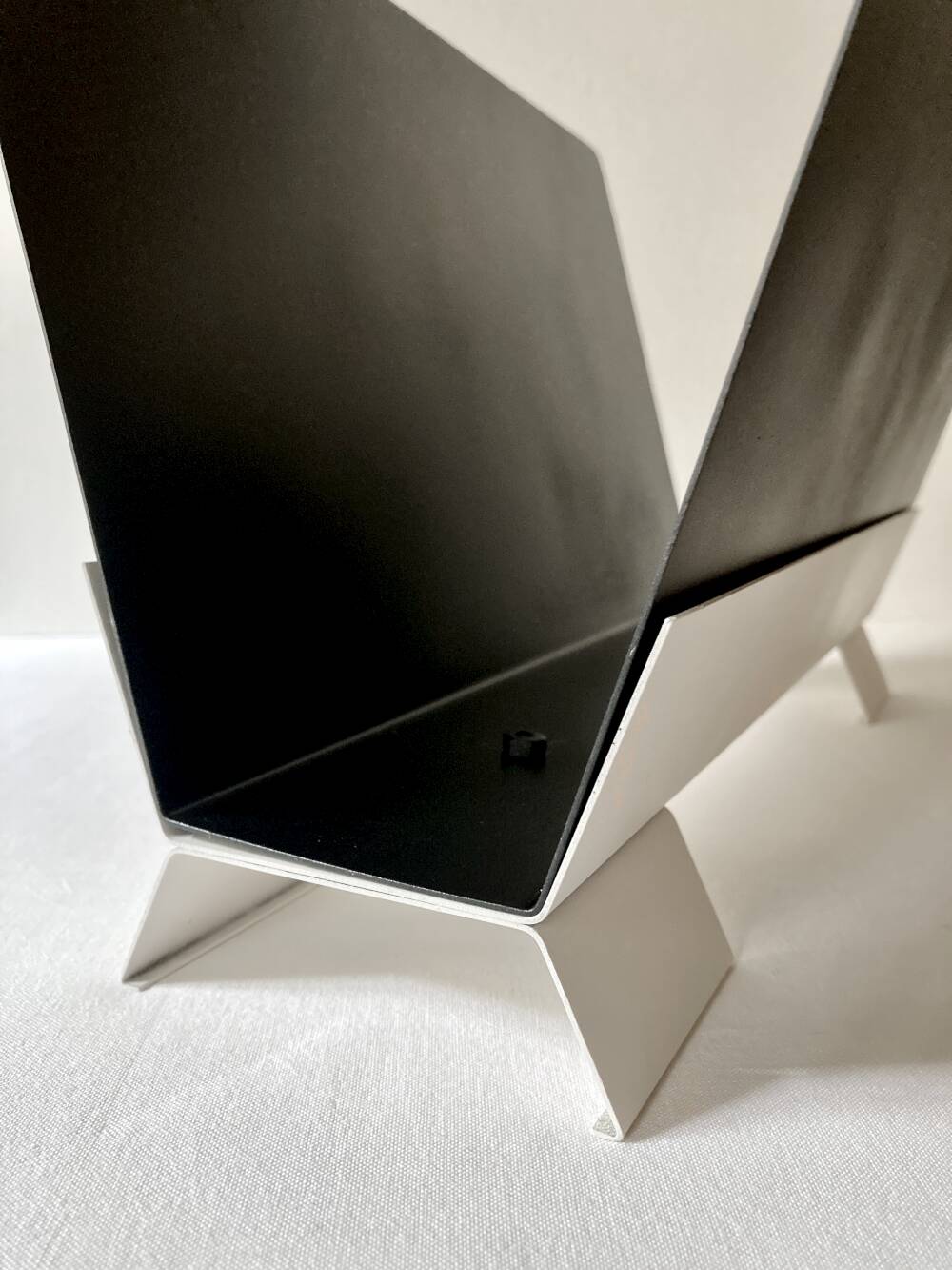 Black and cream metal magazine rack, 1950s.