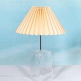 Minimalist glass table lamp from the 80s with a pleated shade.