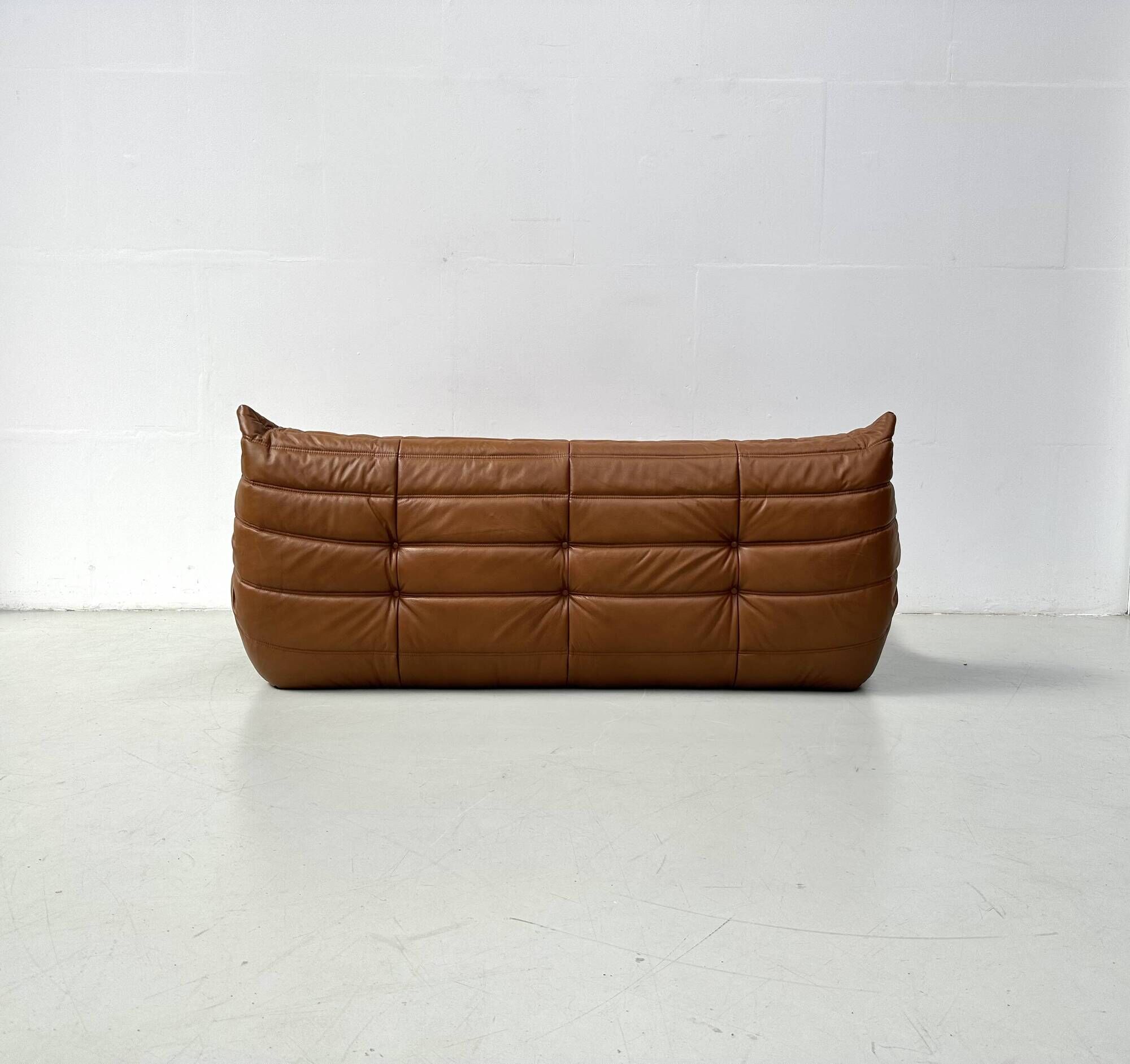 Togo 3-seater in Cognac leather designed by Michel Ducaroy for Ligne Roset.