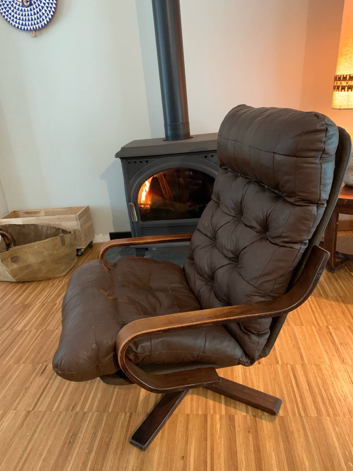 Vintage leather armchair with wooden armrests