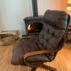 Vintage leather armchair with wooden armrests
