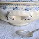 Antique mismatched earthenware soup plates with a tureen