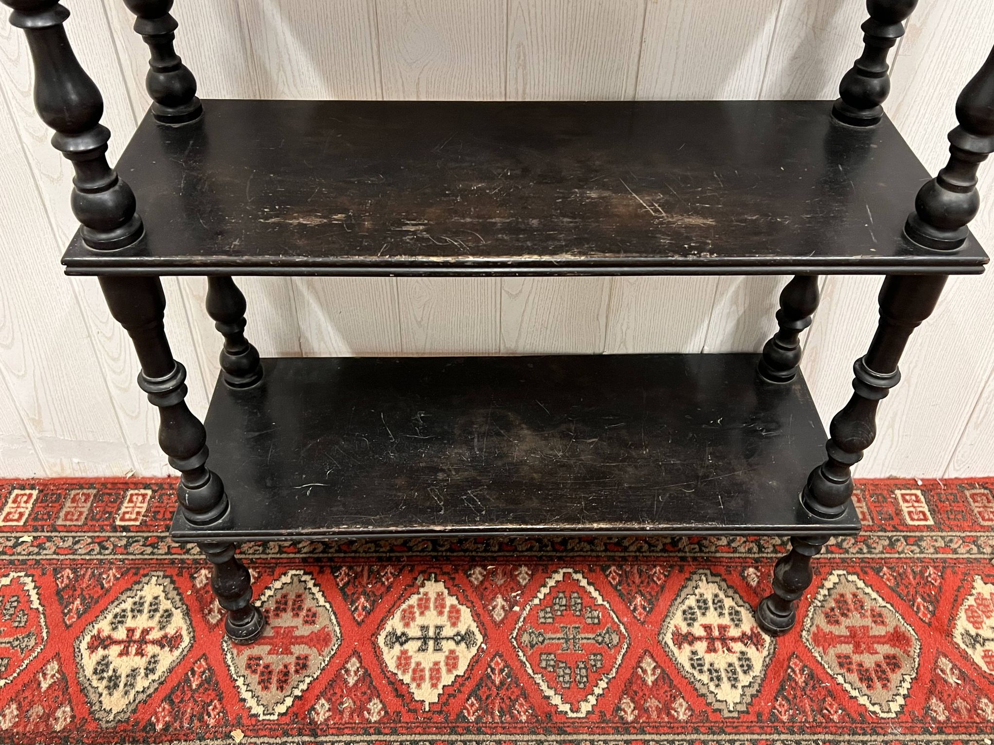 Blackened wooden shelf.