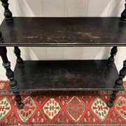 Blackened wooden shelf.