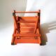 Vintage folding chair in orange painted wood