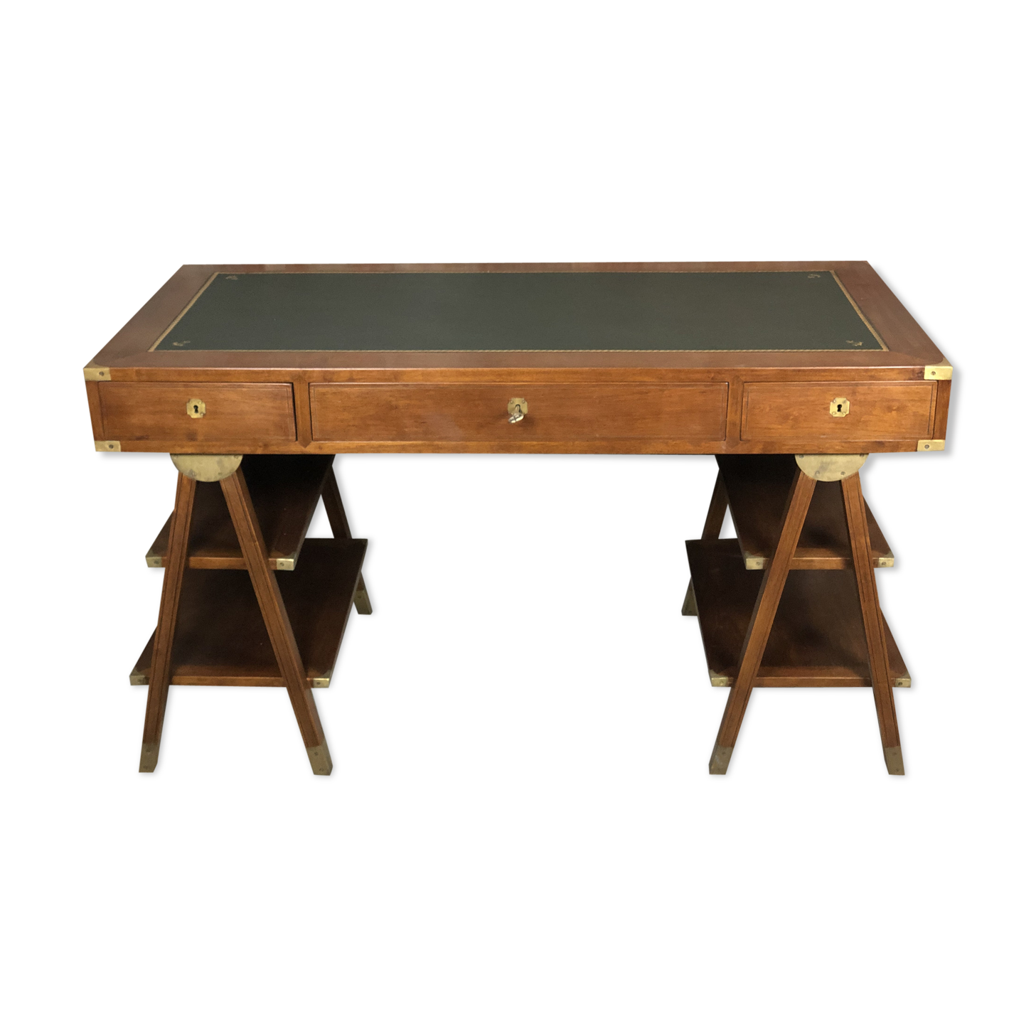 Walnut desk with green leather top resting on two trestles