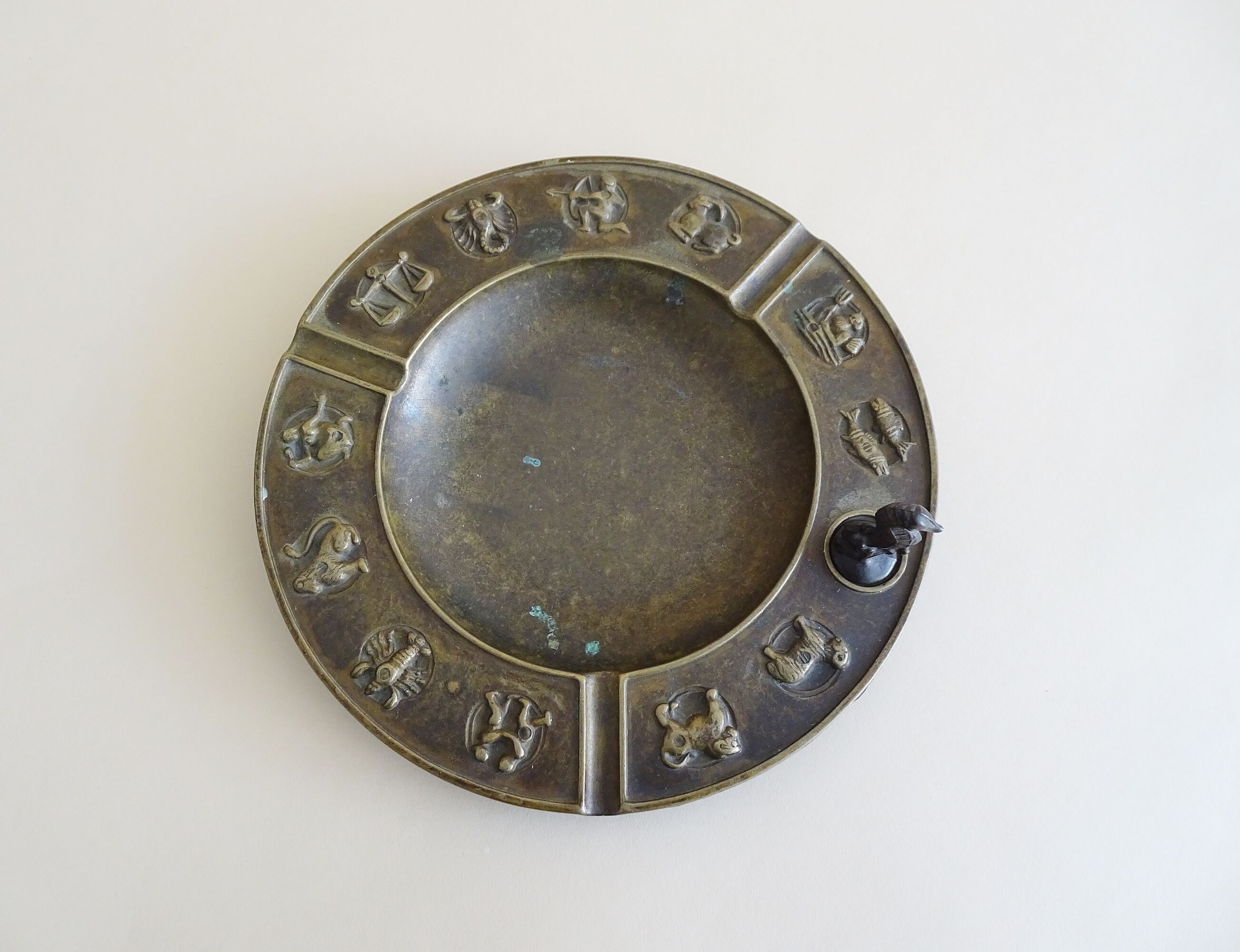 Luxa brass ashtray with zodiac relief and embers killer