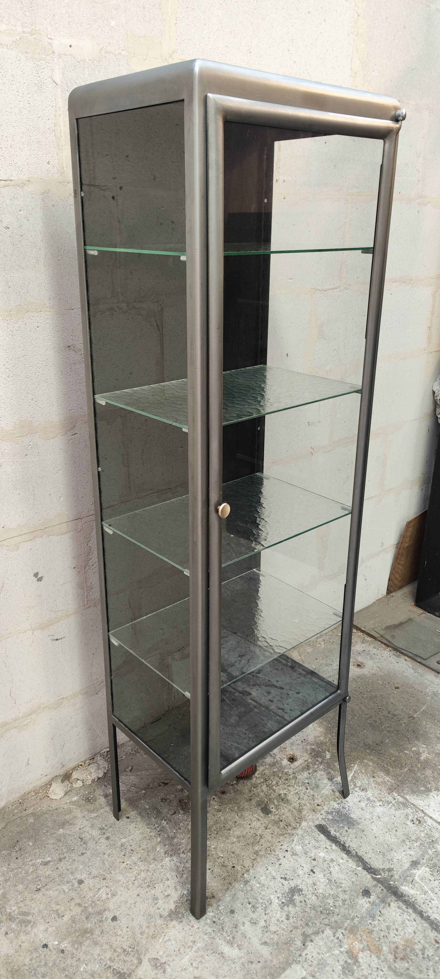 old medical display case with a graphite metal door