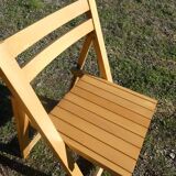 Pair of vintage folding chairs in light wood