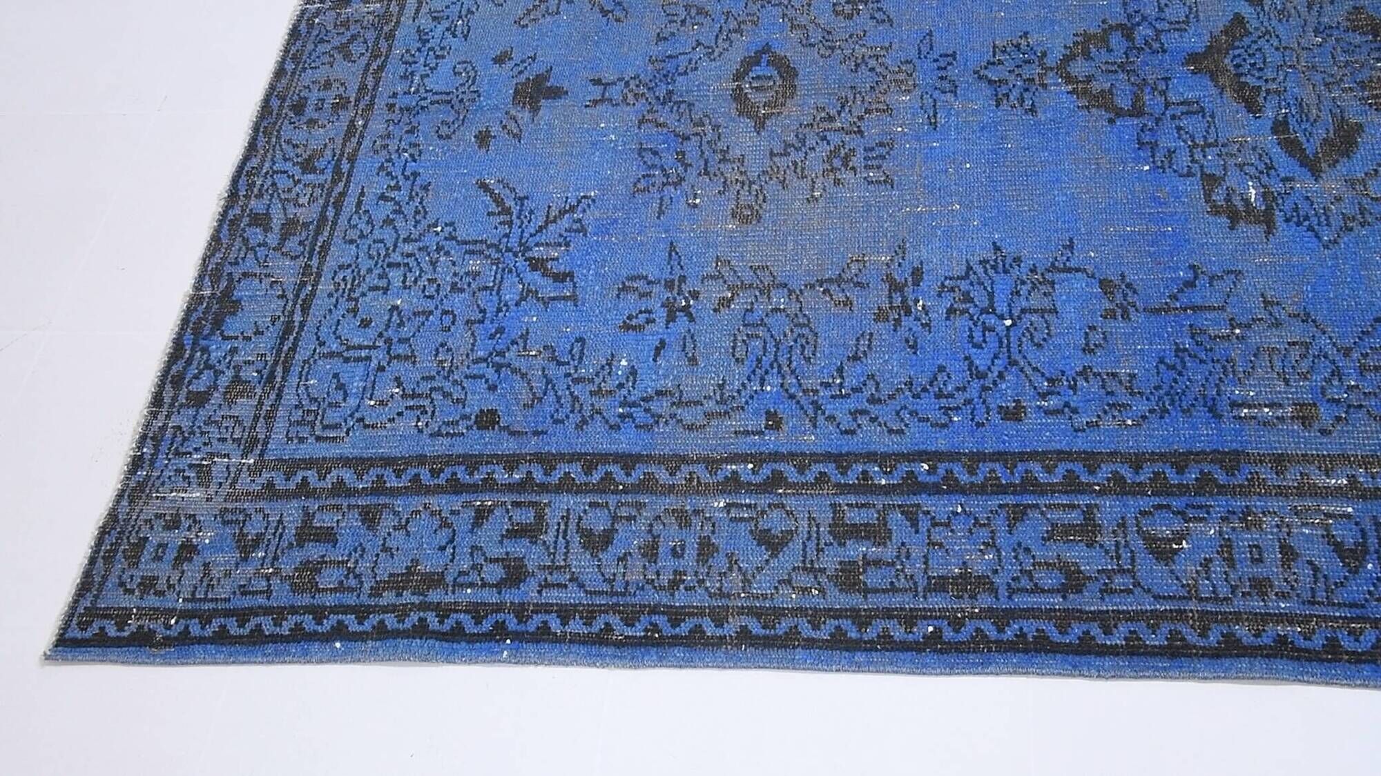 Vintage blue and black Turkish rug with traditional design, 163 × 268 cm